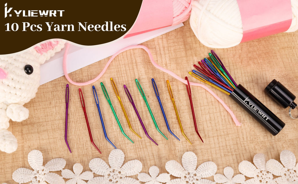 Set of 10 bent yarn darning needles with large eyes, stored in a black aluminum tube, with yarn and a crocheted bunny figure.