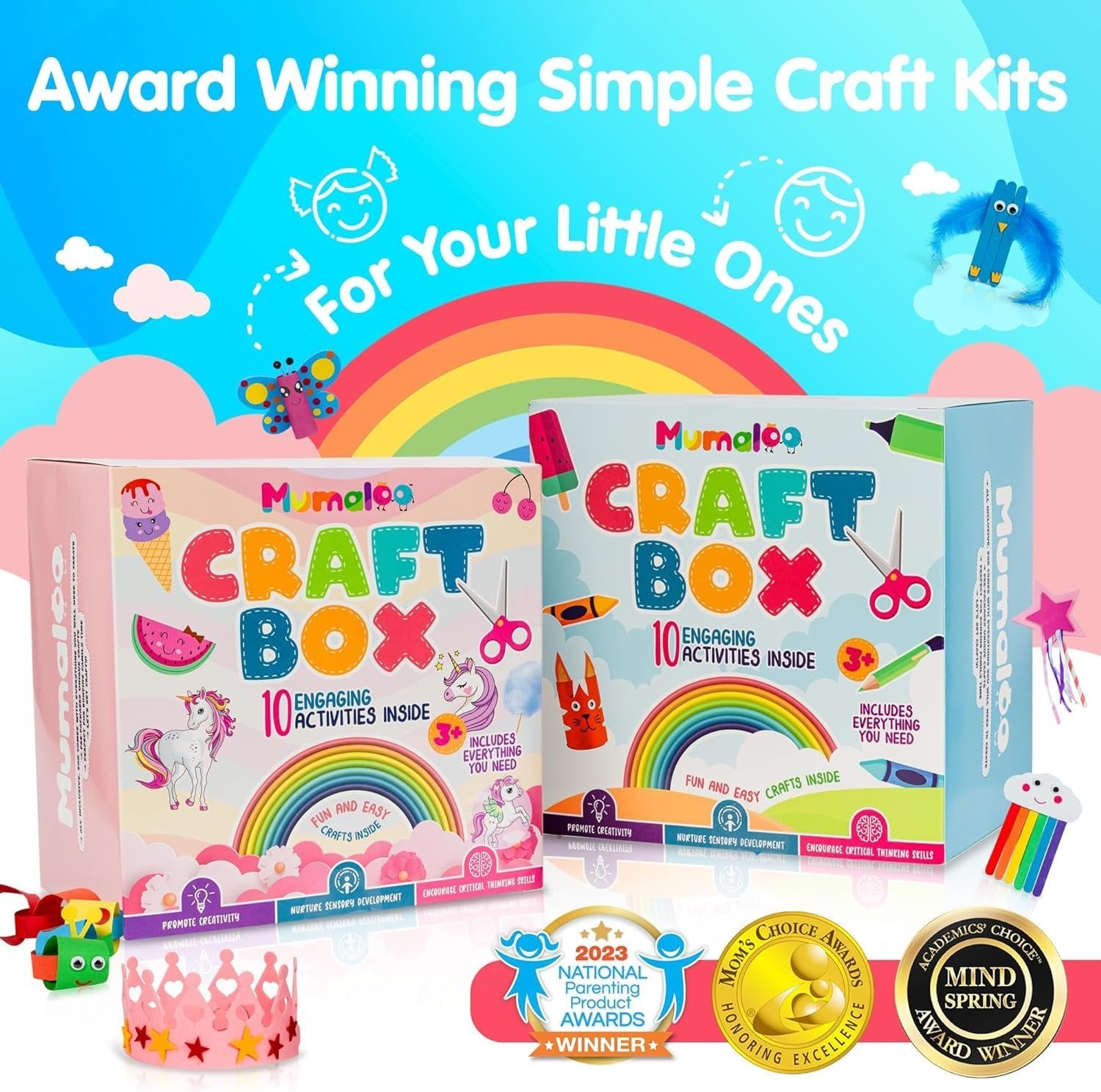 Two craft boxes with art supplies, rainbow graphics, and award badges. A pink crown and craft supplies are in the foreground.