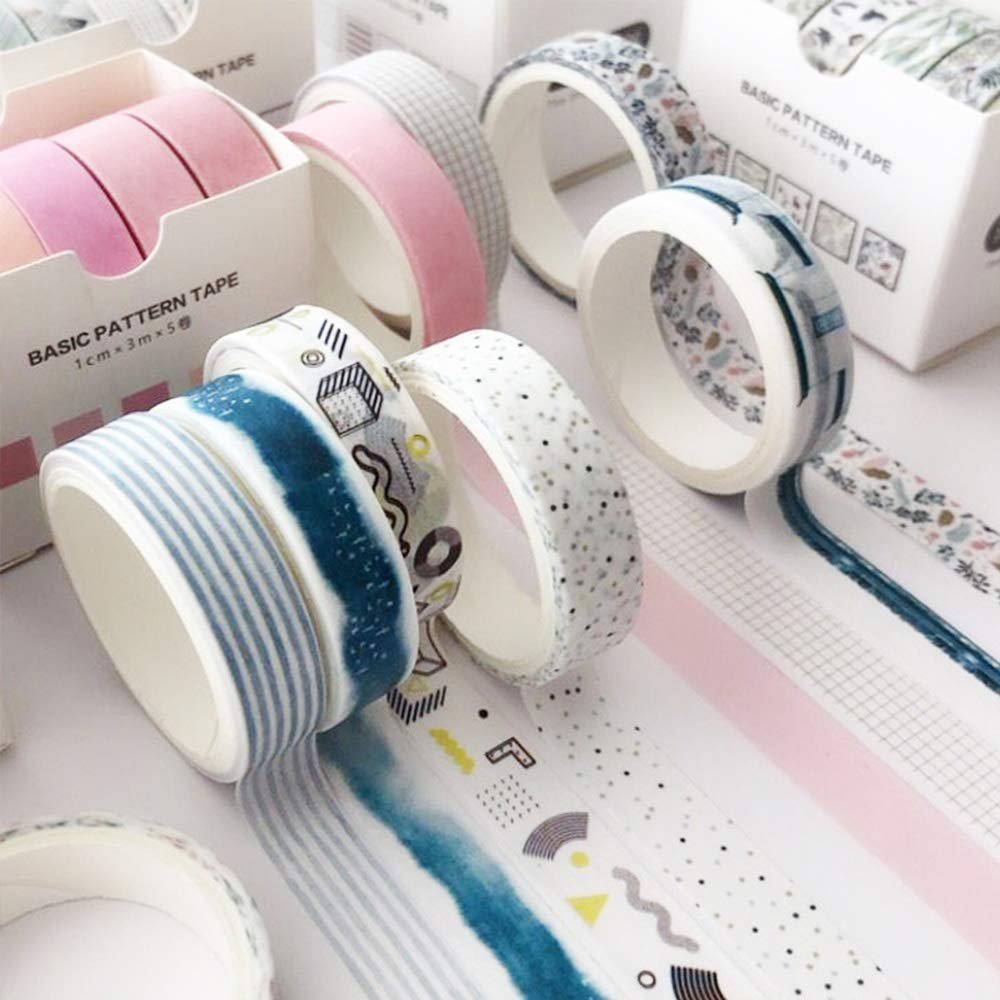 Assortment of decorative washi tape rolls with various patterns including stripes, dots, and abstract designs.