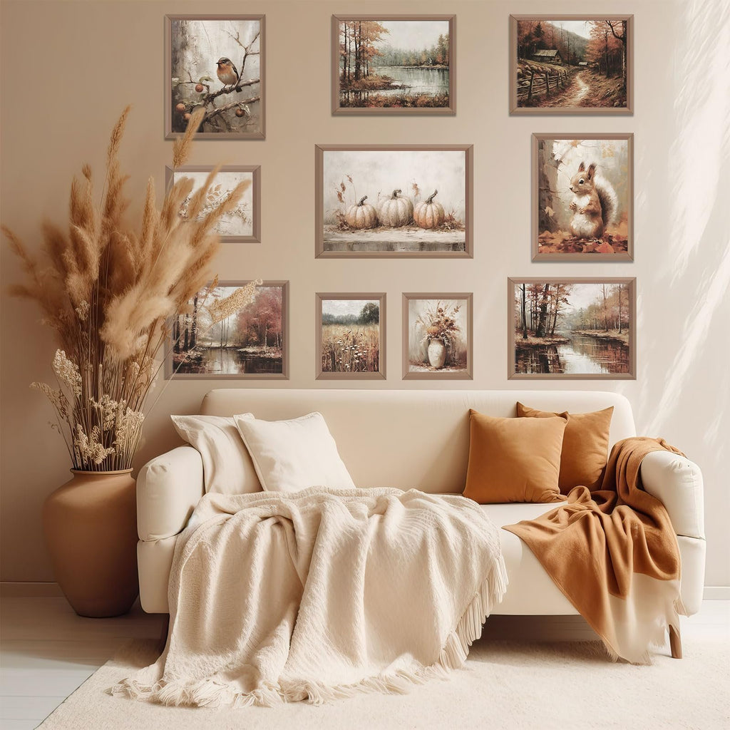 Living room with a sofa adorned with throws and pillows, featuring a gallery wall of ten unframed autumn-themed art prints.