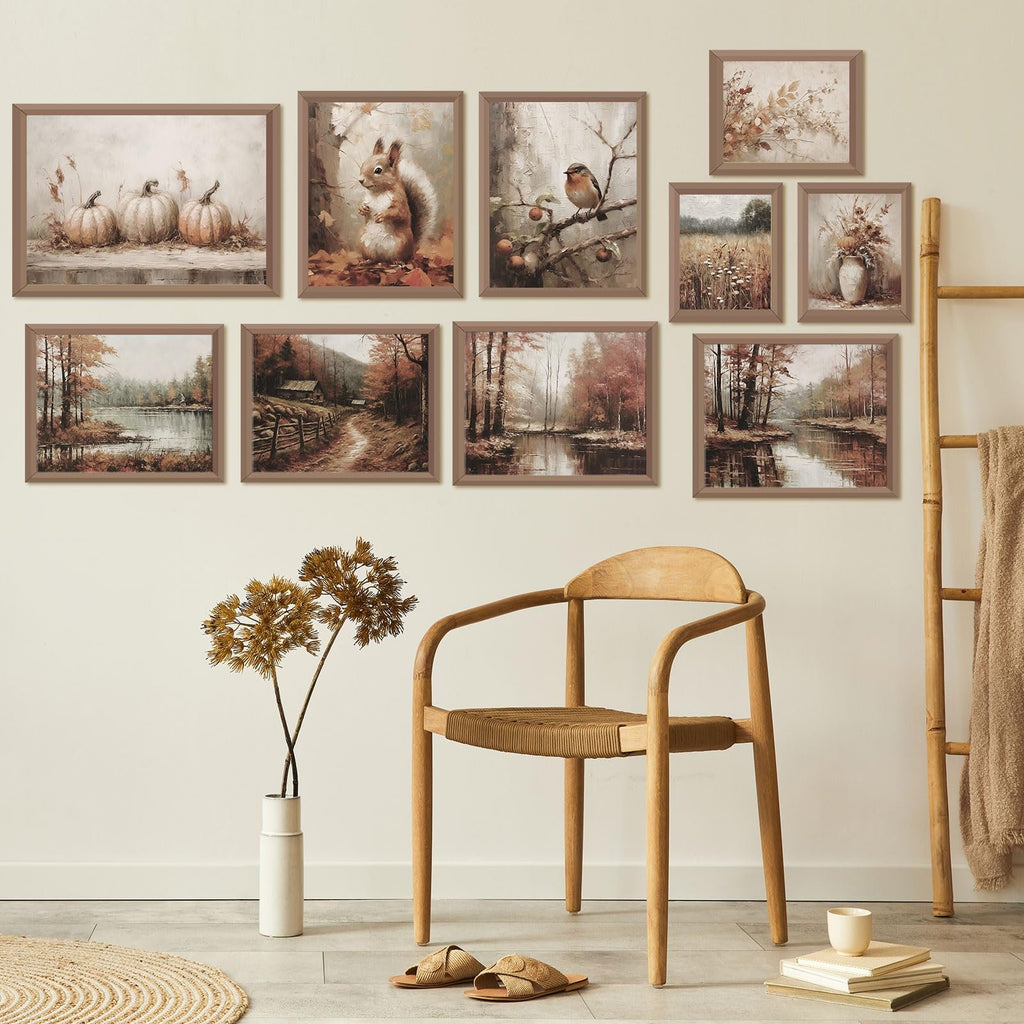 Gallery wall of 10 unframed vintage fall art prints featuring pumpkins, a squirrel, a bird, and autumn landscapes, displayed above a wooden chair and ladder.