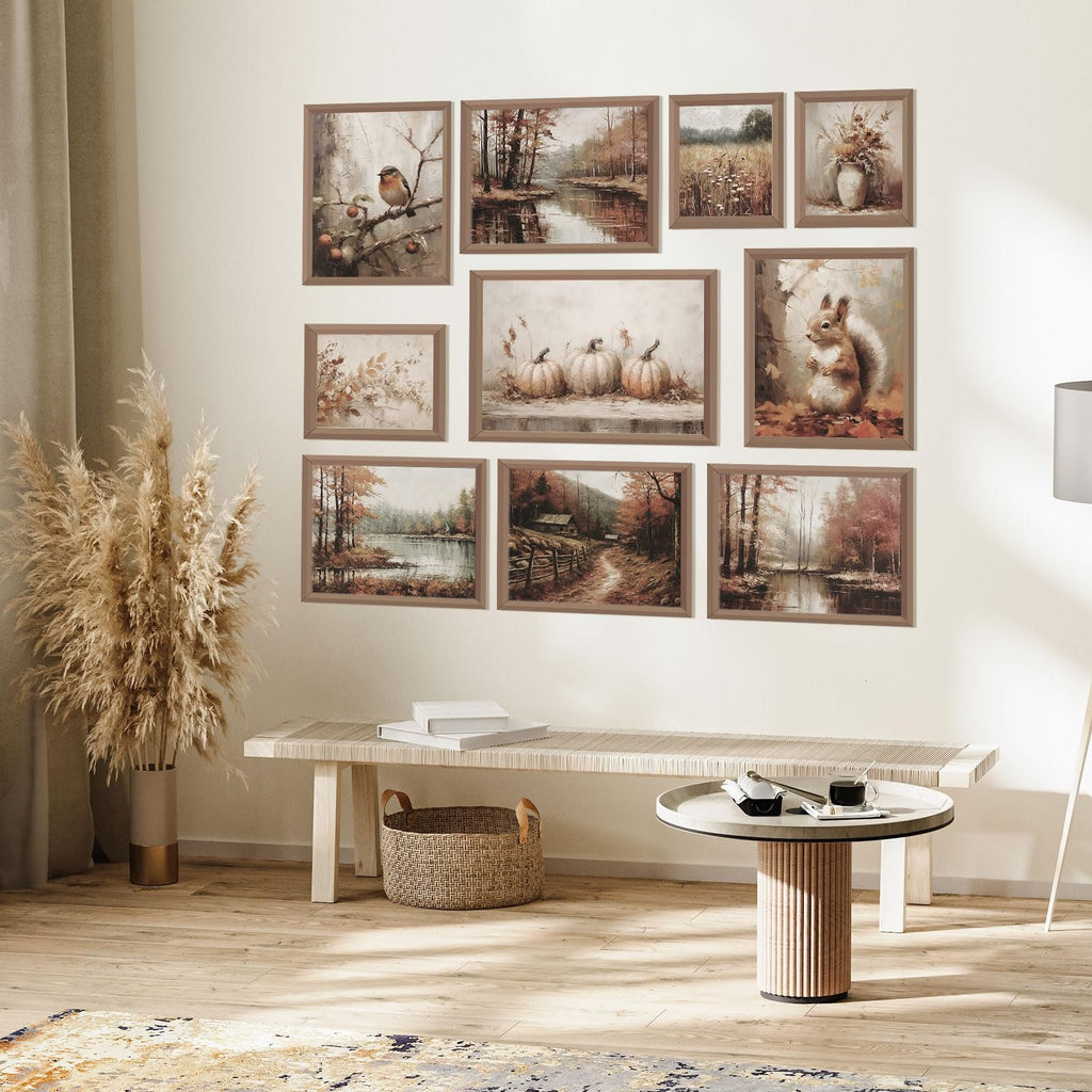 Nine framed vintage fall wall art prints displayed on a wall above a bench and coffee table.