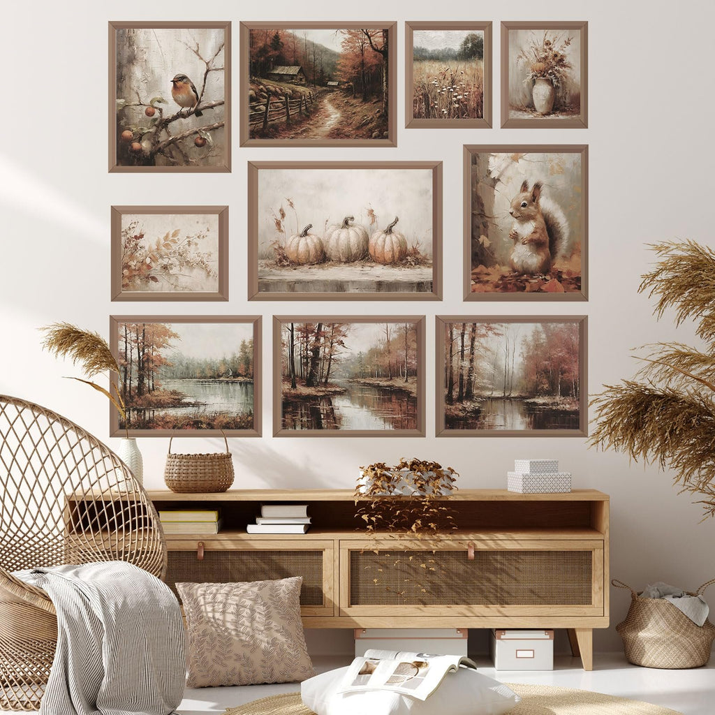 Collection of 10 unframed vintage fall wall art prints displayed on a wall above a wooden cabinet.