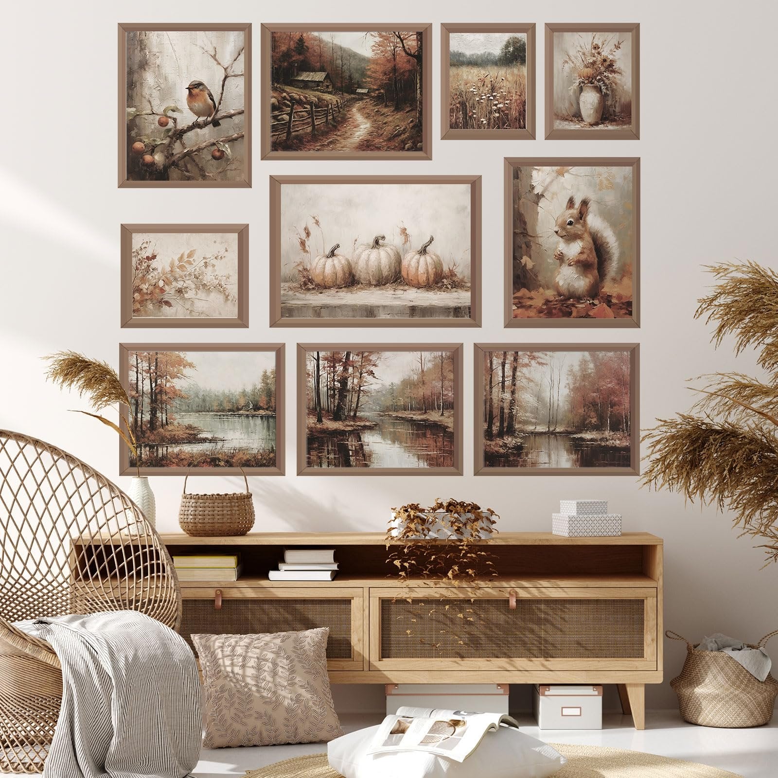 Collection of 10 unframed vintage fall wall art prints displayed on a wall above a wooden cabinet.