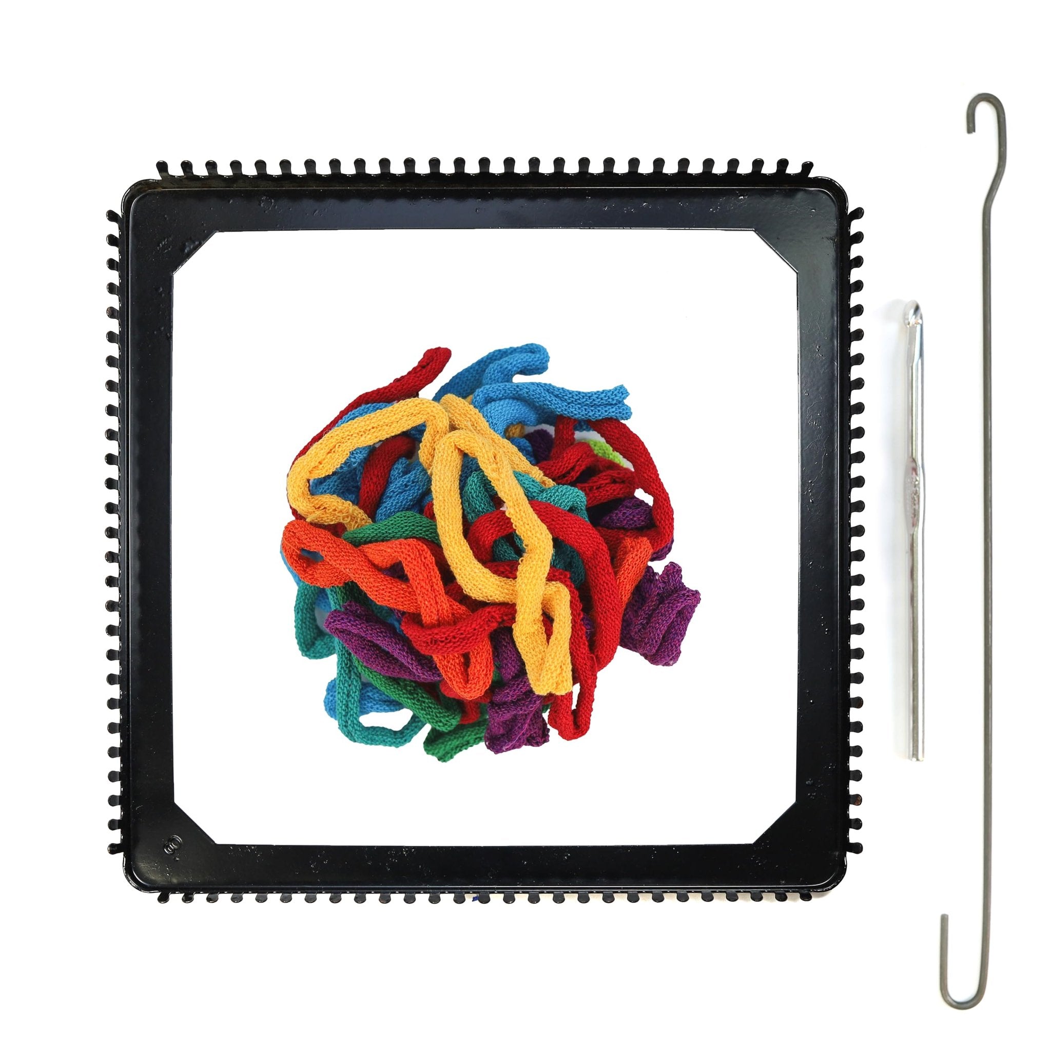 Potholder weaving loom kit with colorful cotton loops and metal tools on a white background