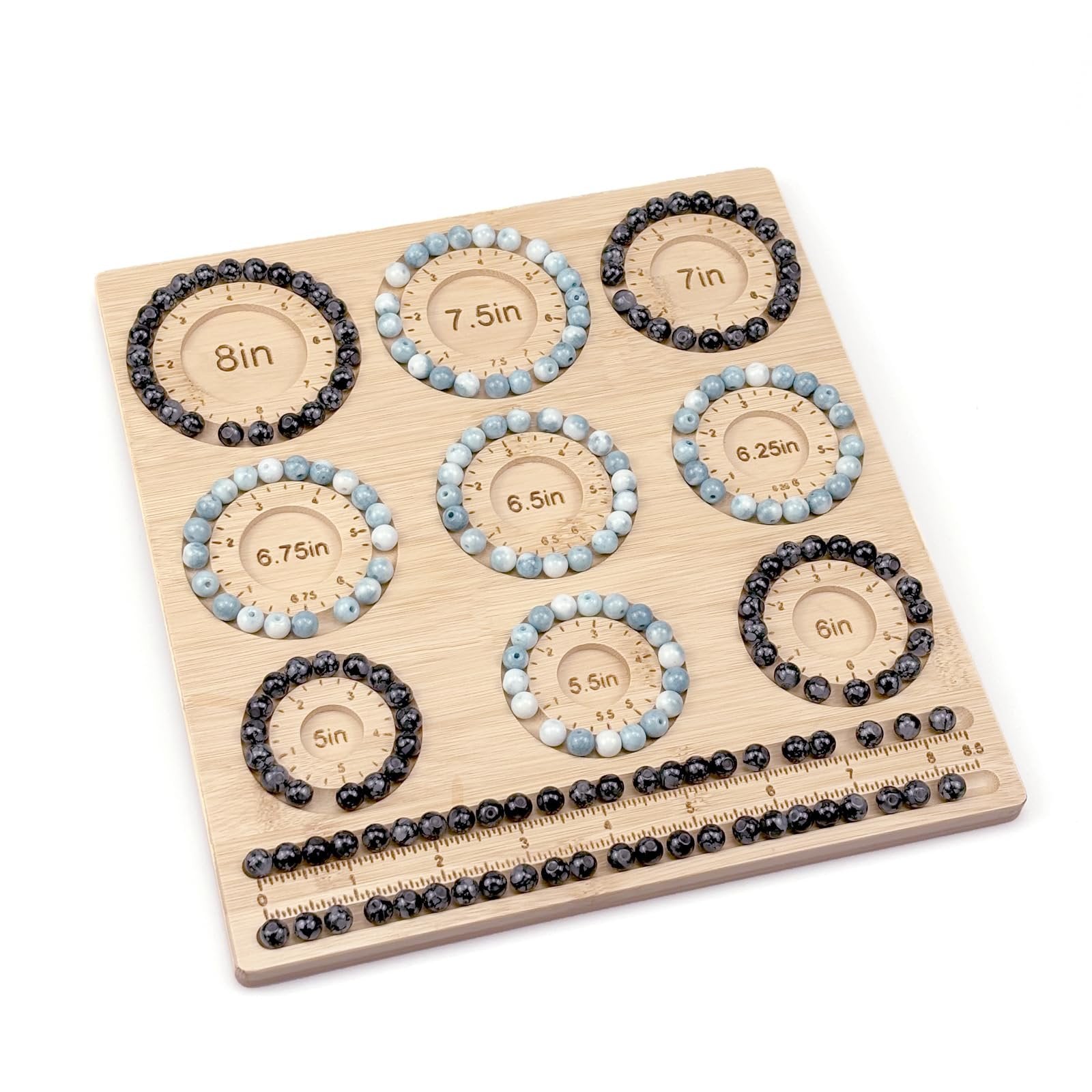 Bamboo beading board with bracelets arranged in size grooves and loose beads in storage slots. Measurements are marked on the board.