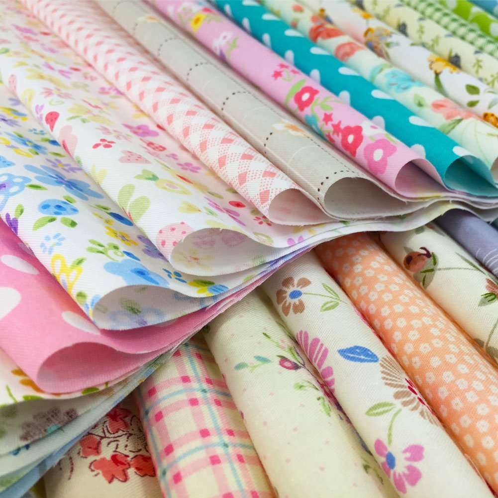 Stack of assorted floral, polka dot, stripe, and gingham fabric squares for crafts
