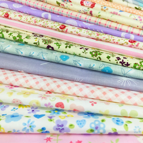 Stack of assorted floral, polka dot, stripe, and gingham fabric squares for sewing and crafts.