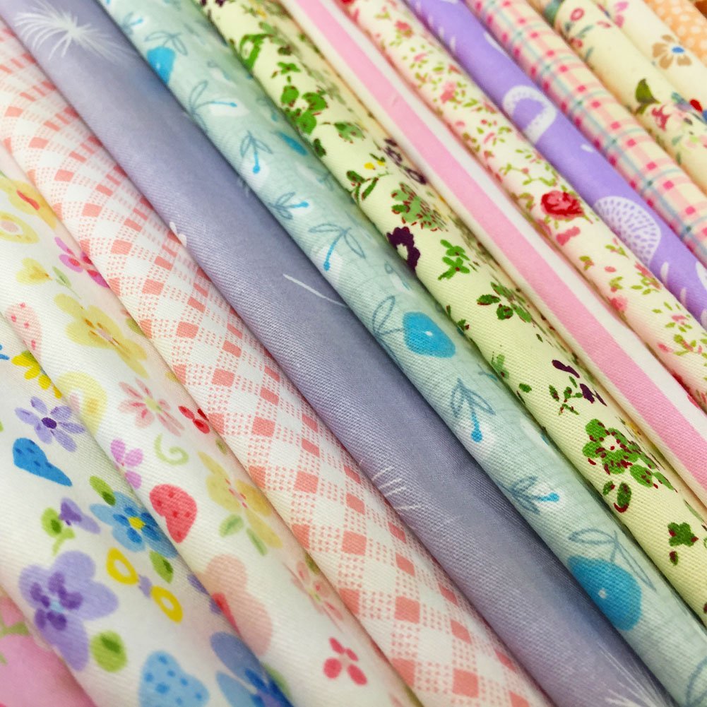 Assorted floral and geometric print cotton fabric squares rolled and stacked, pastel colors