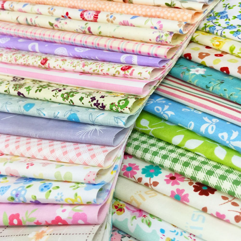 Stack of colorful floral and patterned fabric squares, close-up view showing various designs and colors.
