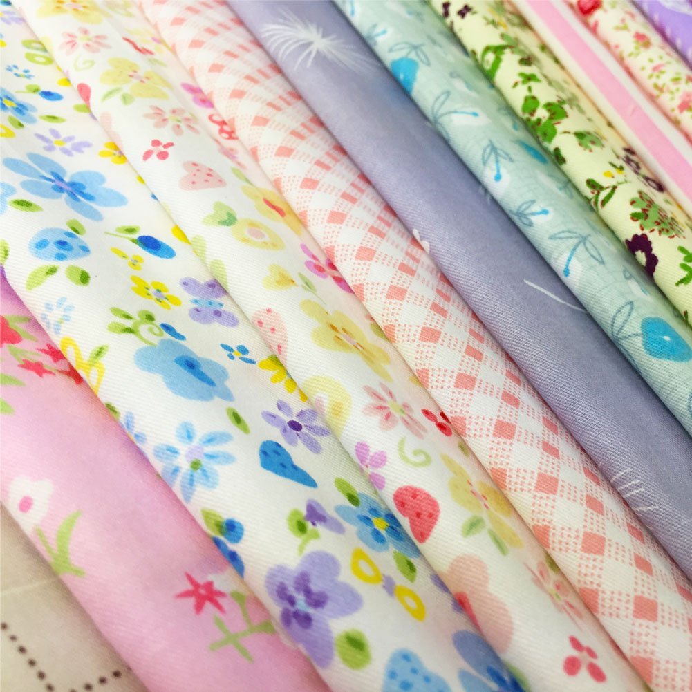 Stack of colorful floral print 100% cotton quilting fabric squares, close-up view.