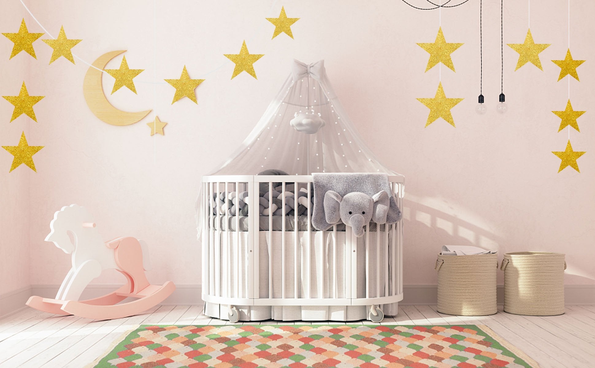 Glitter gold star cutouts and a crescent moon decoration above a crib in a nursery.