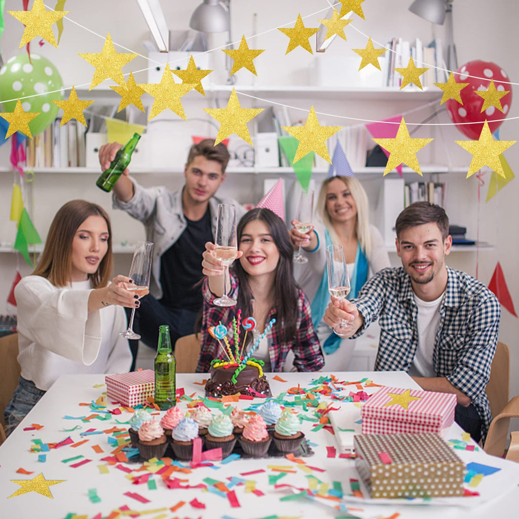 People celebrating a birthday with glitter gold star garlands, cupcakes, and cake.
