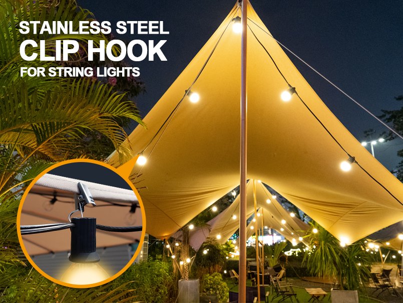 Close-up of stainless steel clip hooks holding string lights under a tan canopy at night.