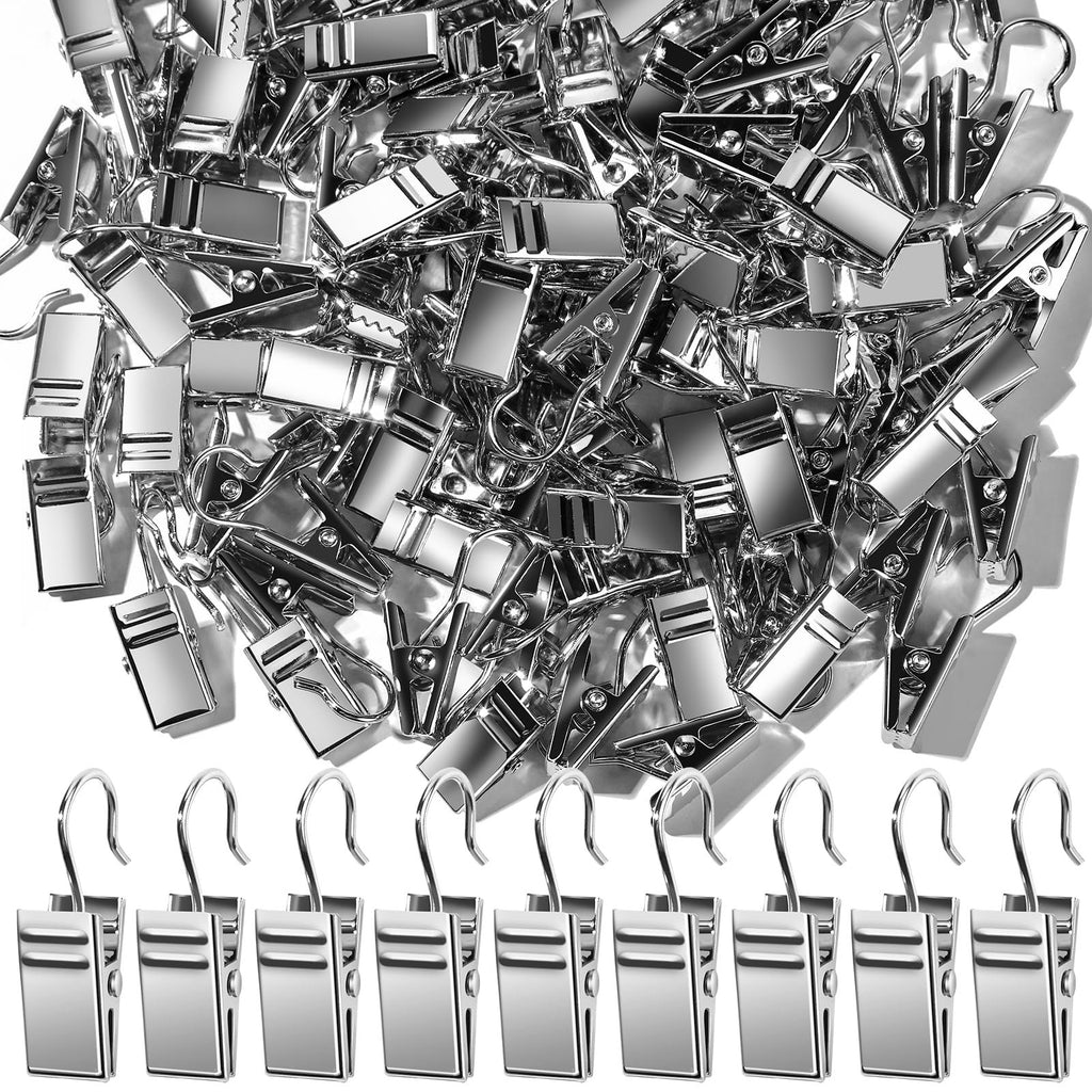 Pile of small silver metal clip hooks with a row of hooks on display against a white background