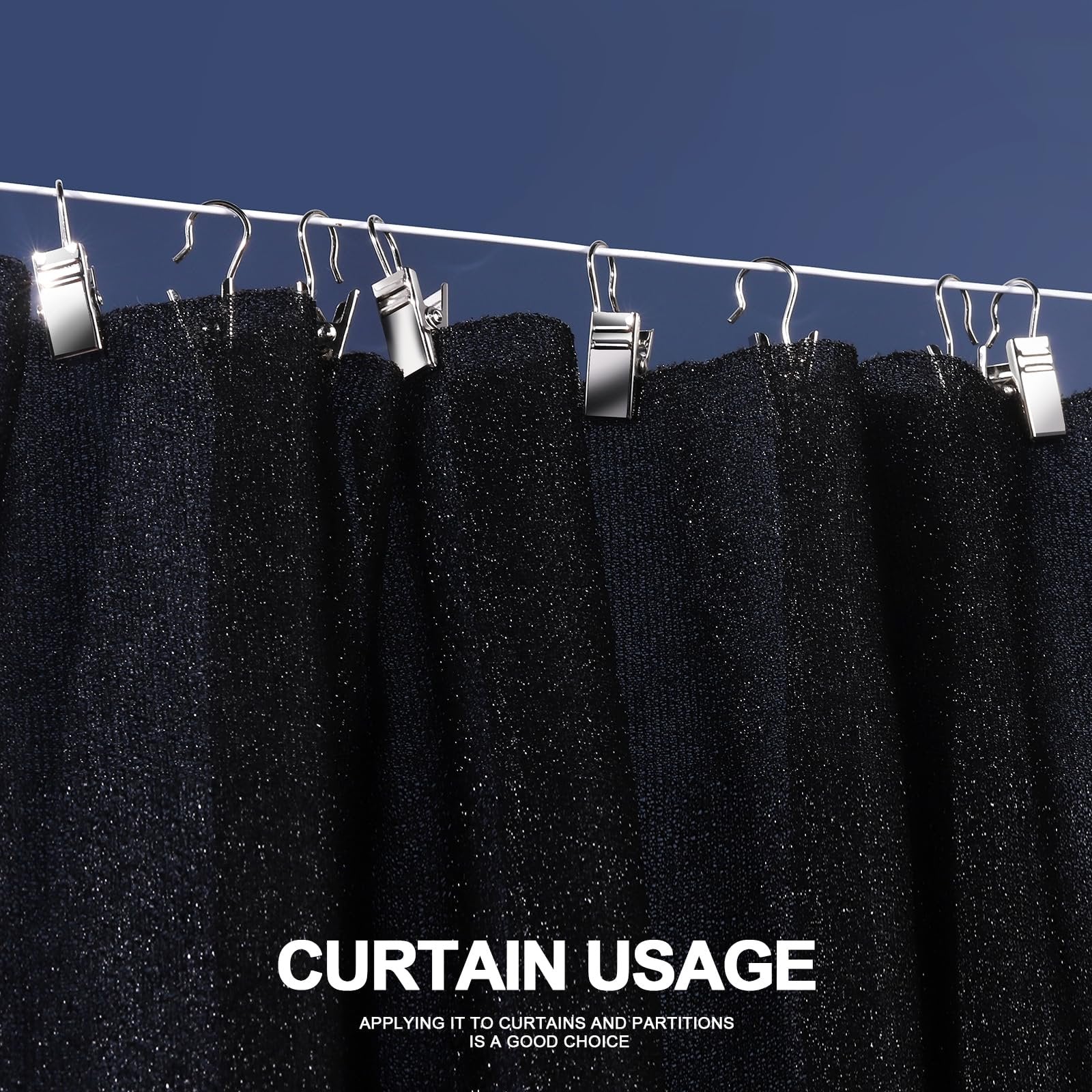 Close-up of small stainless steel clip hooks holding black fabric on a white rod against a dark blue background.