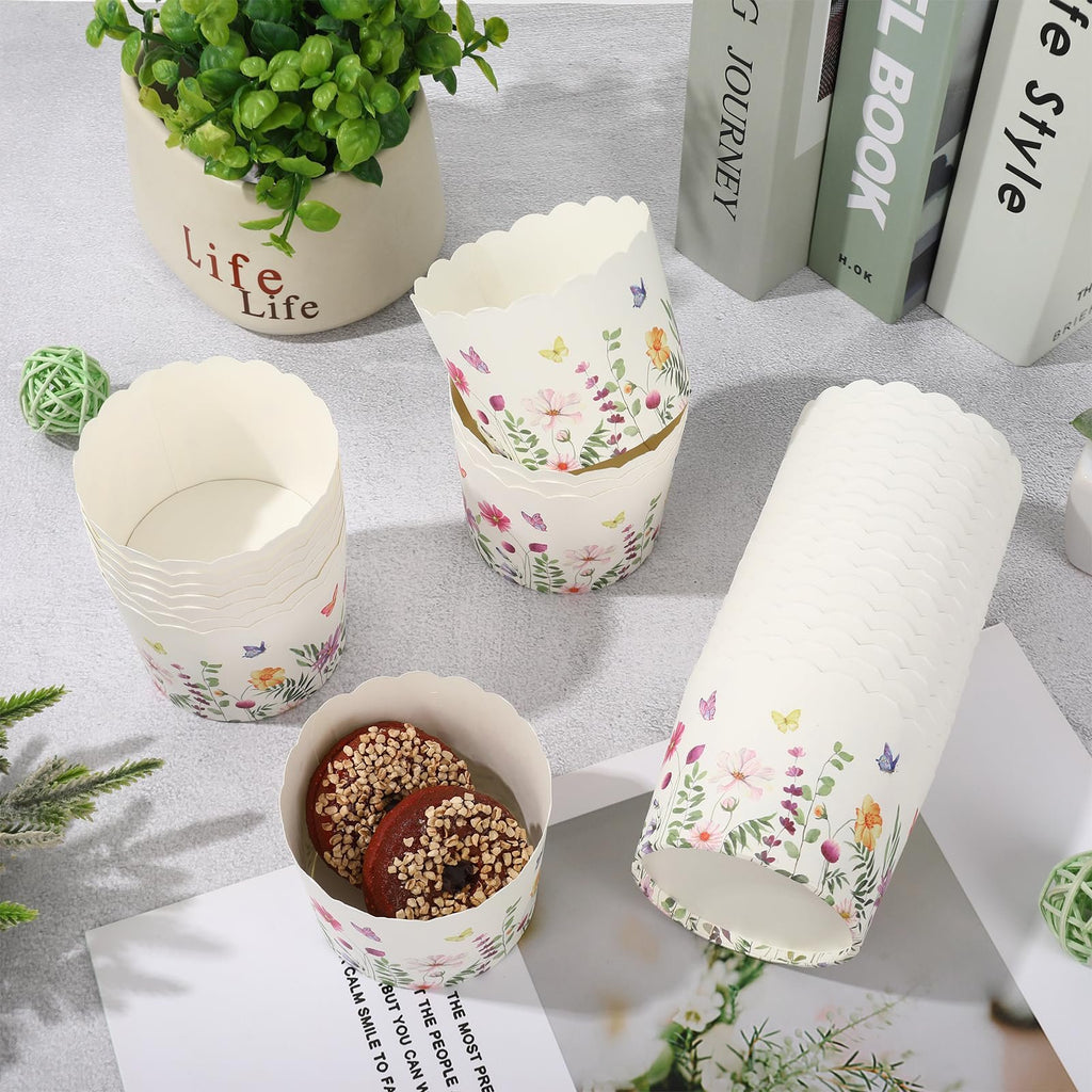 Wildflower paper baking cups with scalloped edges, some stacked, one holding two donuts, on a flat surface with decorative elements.