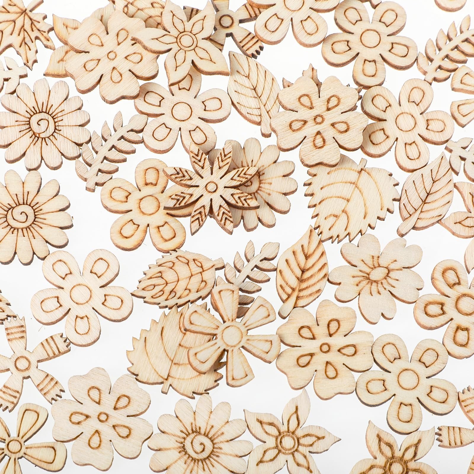 Assortment of 20mm unfinished wooden flower and leaf craft cutouts scattered on a white background.
