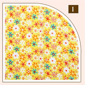 Yellow cotton fabric squares with small multicolor floral print, close-up view.