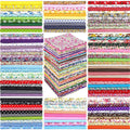 Collage of stacked fabric squares in various floral and patterned designs, arranged in multiple piles.