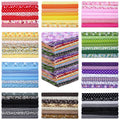 Stacks of multicolor floral and patterned cotton quilting fabric squares, 10x10 inches.
