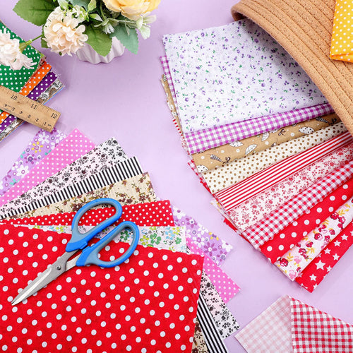 Stack of multicolor floral and patterned fabric squares with blue scissors and a ruler on a lavender background.