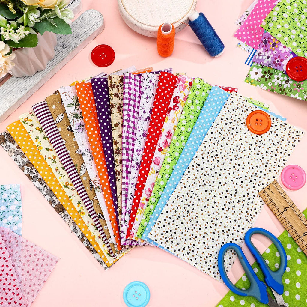 Assortment of colorful floral and patterned cotton fabric squares with sewing notions like buttons, thread, and a ruler.