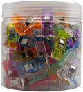 Jar filled with colorful sewing clips for fabric, quilting, and binding.