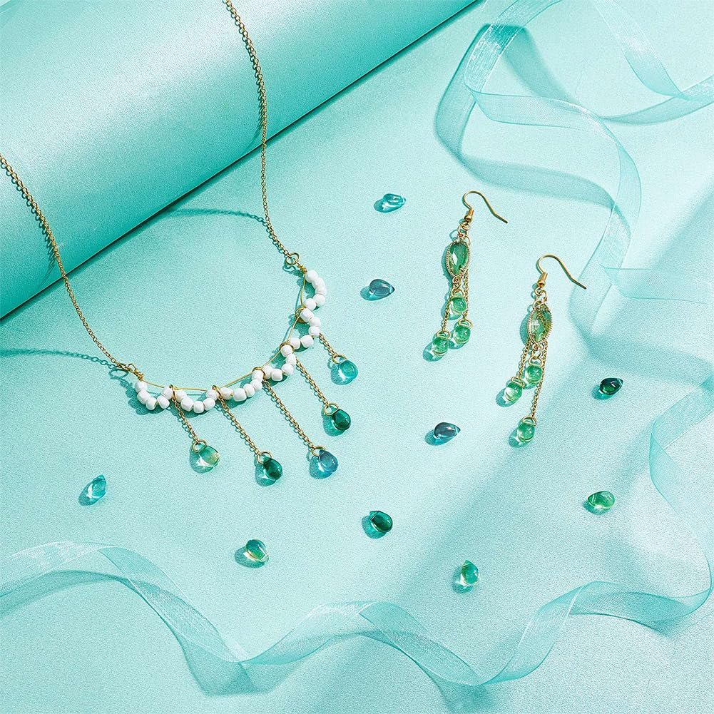 Teardrop Czech glass beads and finished necklace and earrings on a teal background with ribbon accents.