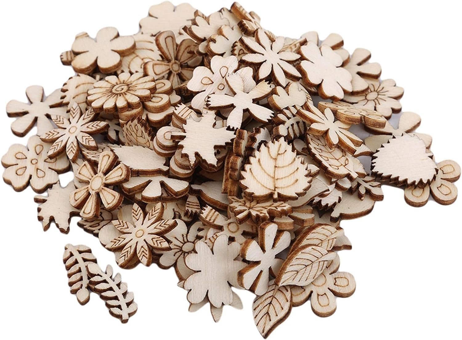 Pile of unfinished wooden flower and leaf craft cutouts on a white background.