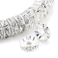 Silver plated rondelle spacer beads with clear rhinestones, close-up on white background