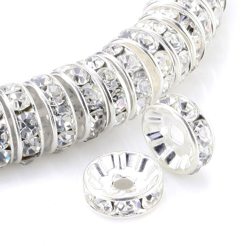 Silver plated rondelle spacer beads with clear rhinestones, close-up on white background