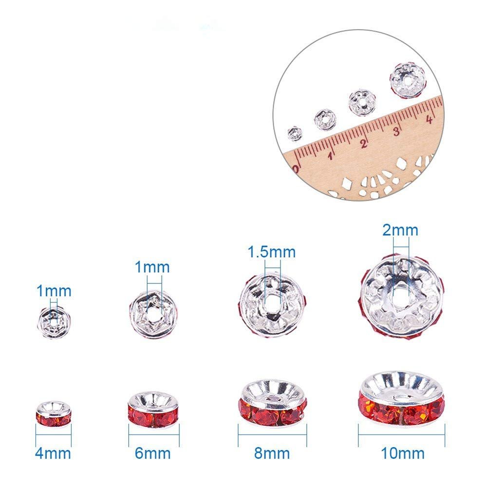 Various sizes of silver plated crystal rondelle spacer beads with red rhinestones and ruler for scale