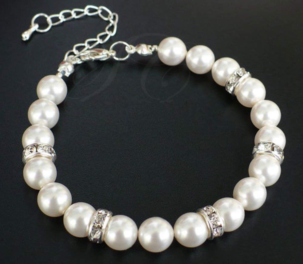 Pearl bracelet with silver-tone chain and rhinestone spacer beads on a black background