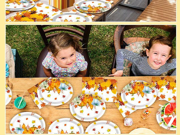 Two young girls at a table set with fall-themed paper plates and napkins featuring pumpkins and maple leaves.
