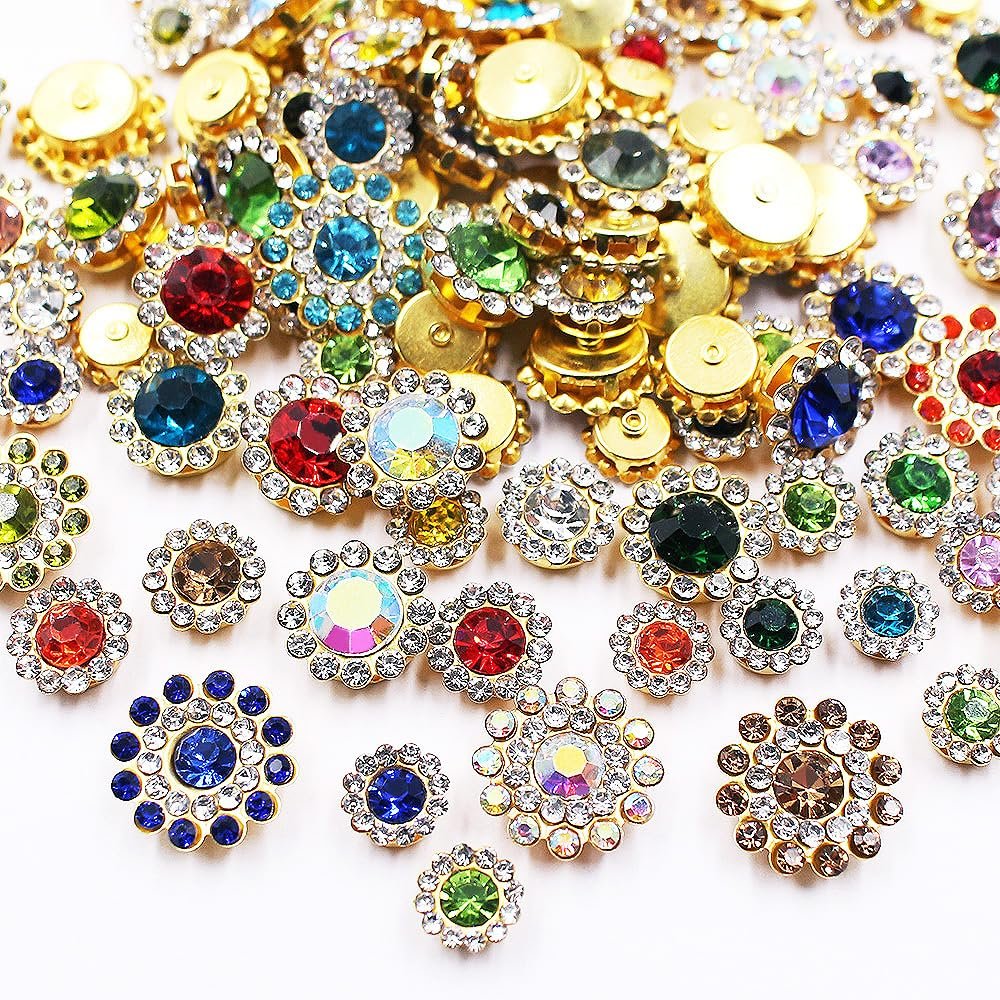 Assortment of mixed color sunflower shape sew-on rhinestones with gold settings on a white background.