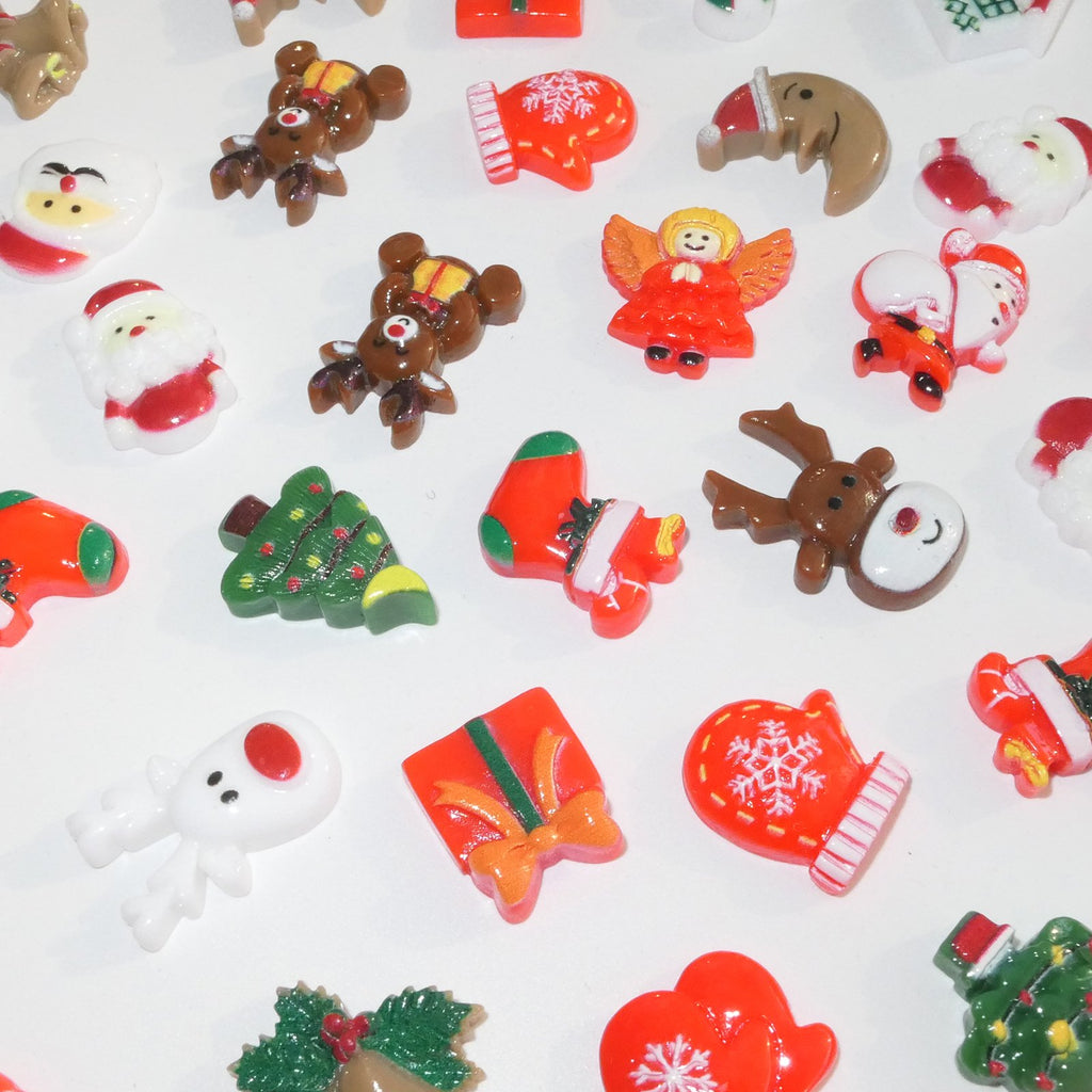 Assorted 3D resin Christmas charms including Santas, reindeer, angels, stockings, and trees on a white background.