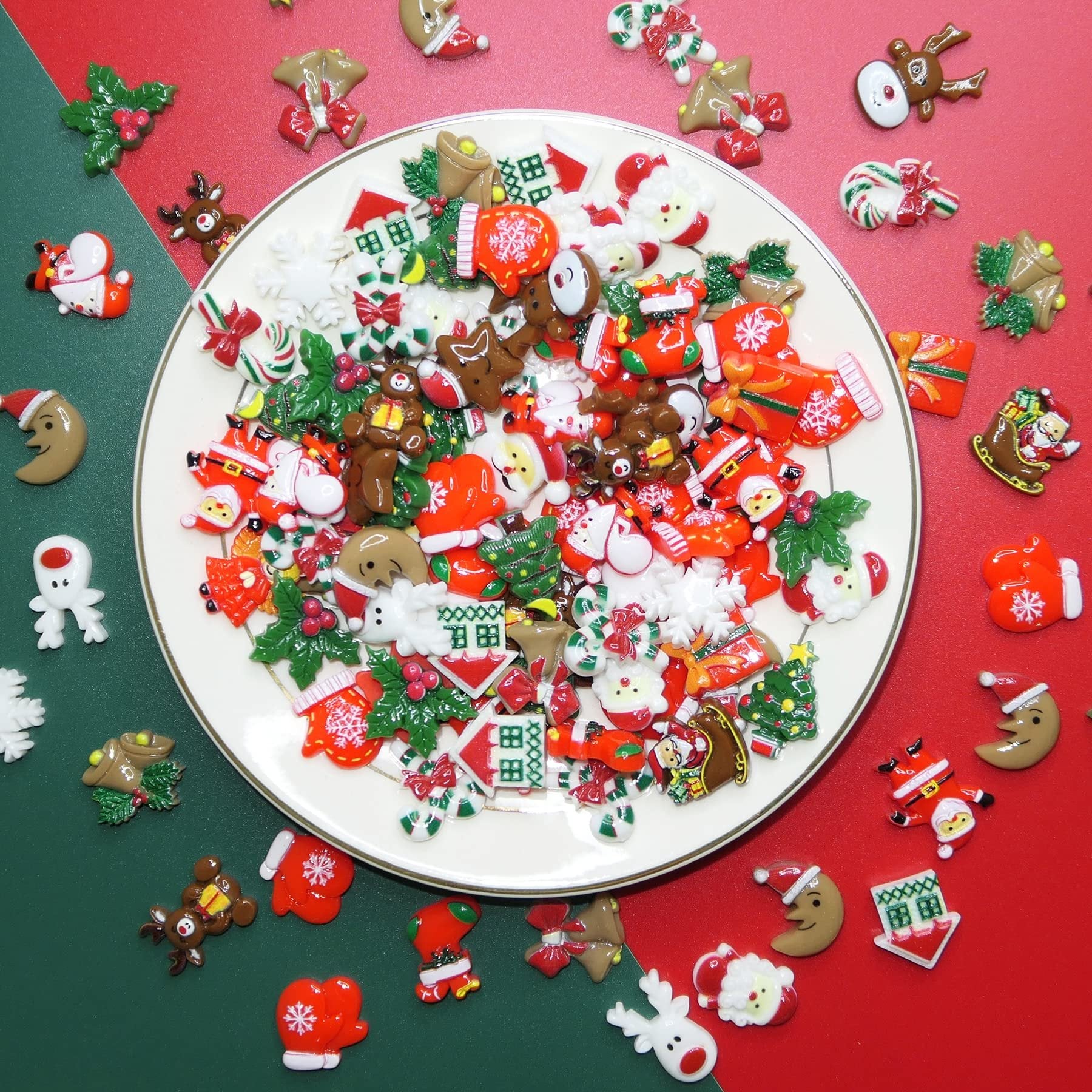 Assorted 3D Christmas resin charms including Santas, reindeer, gingerbread men, and candy canes on a white plate.