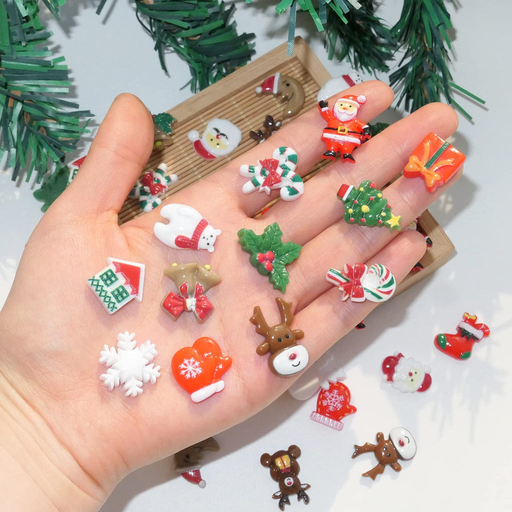 Hand holding assorted 3D Christmas resin charms including Santa, reindeer, snowflake, and candy cane.