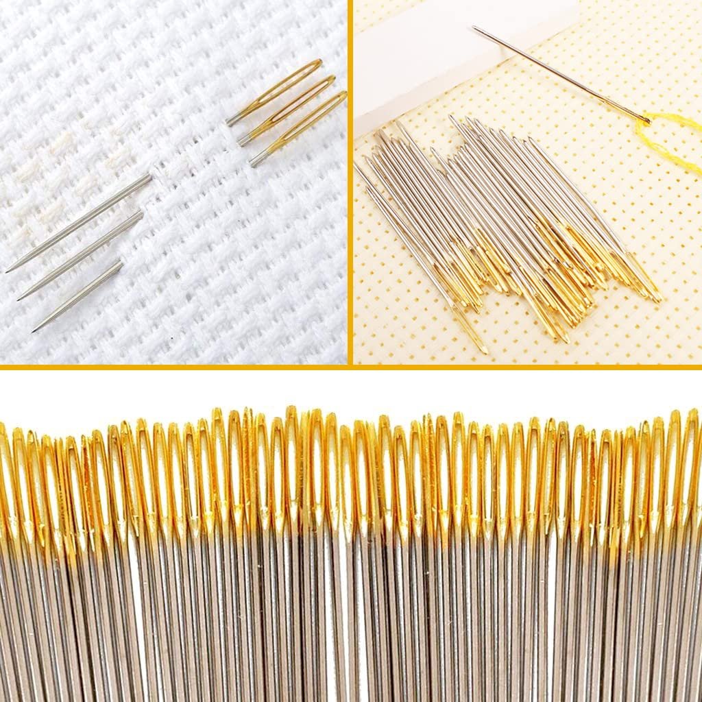 Close-up of golden-eyed hand sewing needles and threaders on white cross-stitch fabric and patterned cloth