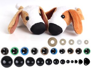 Assorted sizes of black plastic safety eyes and washers with two plush dog heads in the background.
