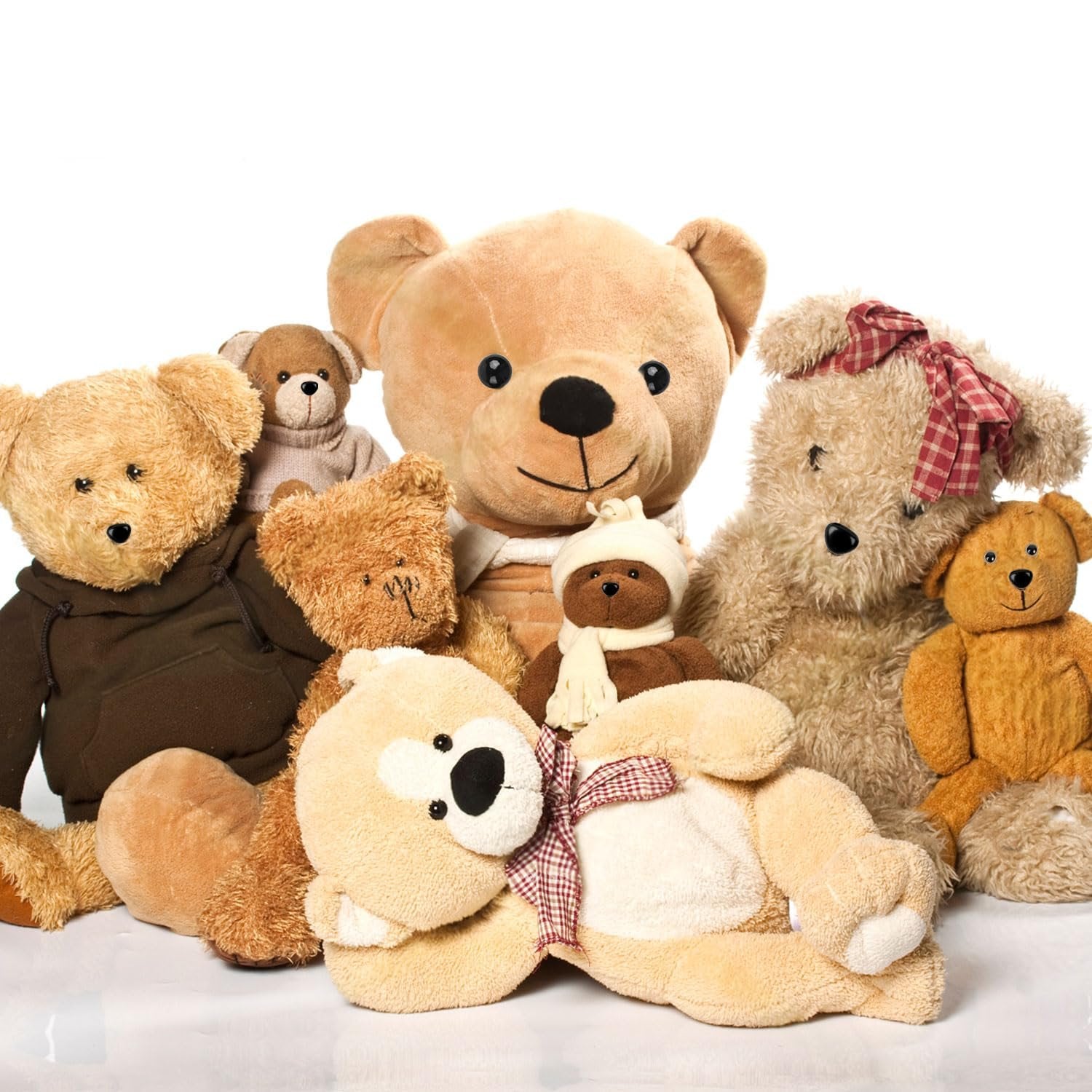 Assortment of plush teddy bears of various sizes and colors arranged on a white background.