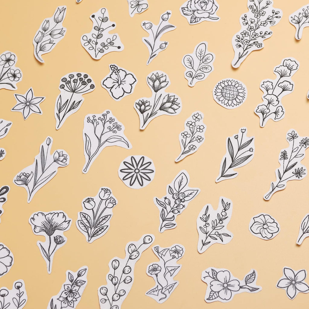 Assortment of 100 pre-printed floral embroidery patterns on water-soluble stabilizer paper, scattered on a peach background.