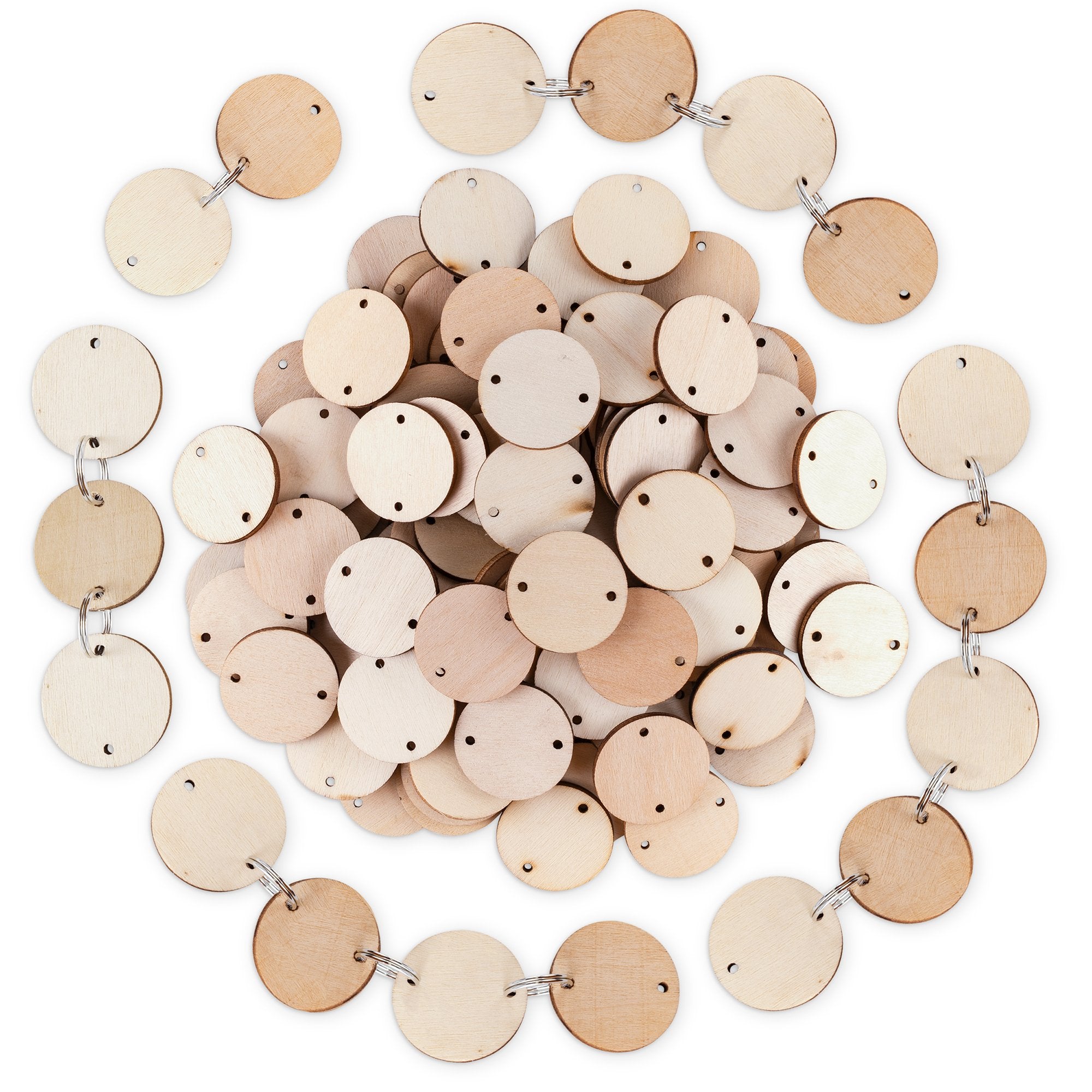 Pile of unfinished wooden circles with holes, some linked by key rings, on a white background.