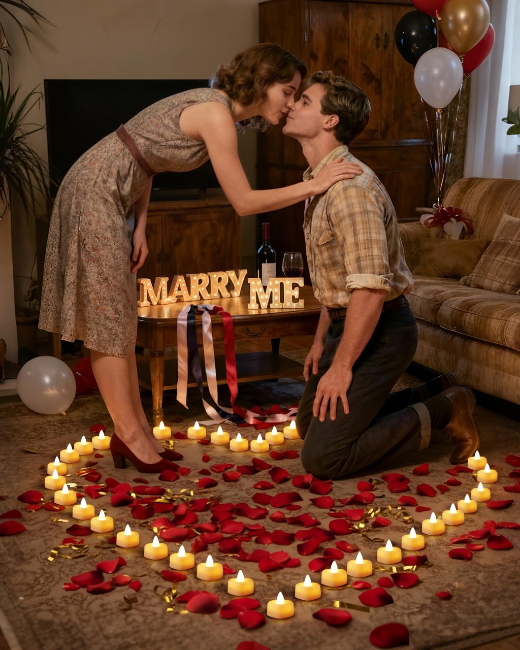Couple kissing surrounded by rose petals and LED tea lights, with 'MARRY ME' marquee letters on a table