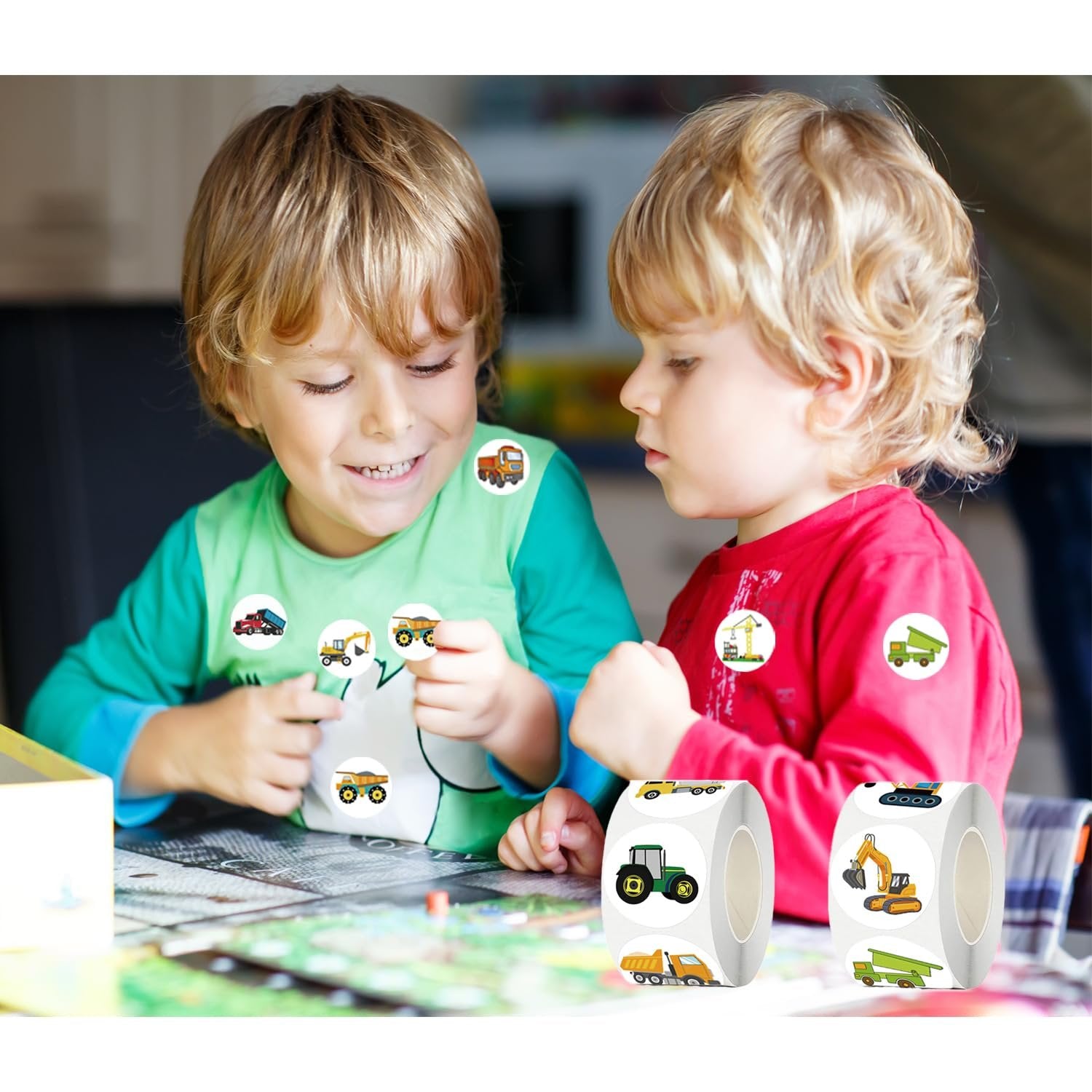 Two young boys looking at cartoon truck and car stickers on their shirts and on rolls of stickers.