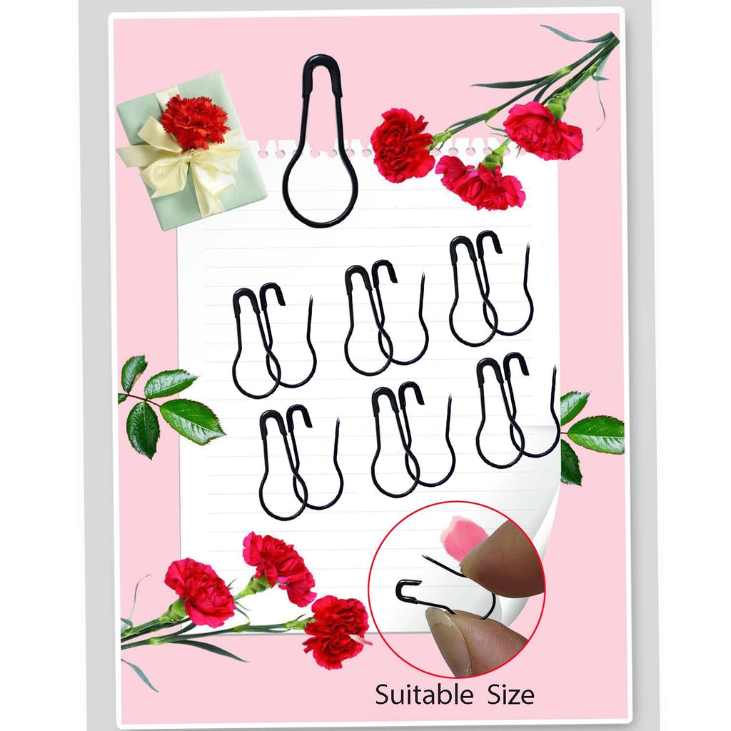 Black gourd-shaped safety pins arranged on lined paper with floral accents and a size demonstration.