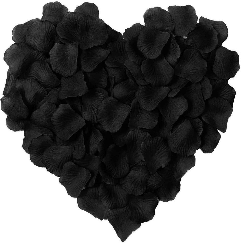 Heart shape made of black artificial silk rose petals on a white background