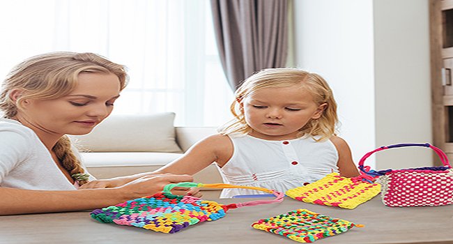 Woman and child weaving colorful loom loops into potholders and a basket on a table