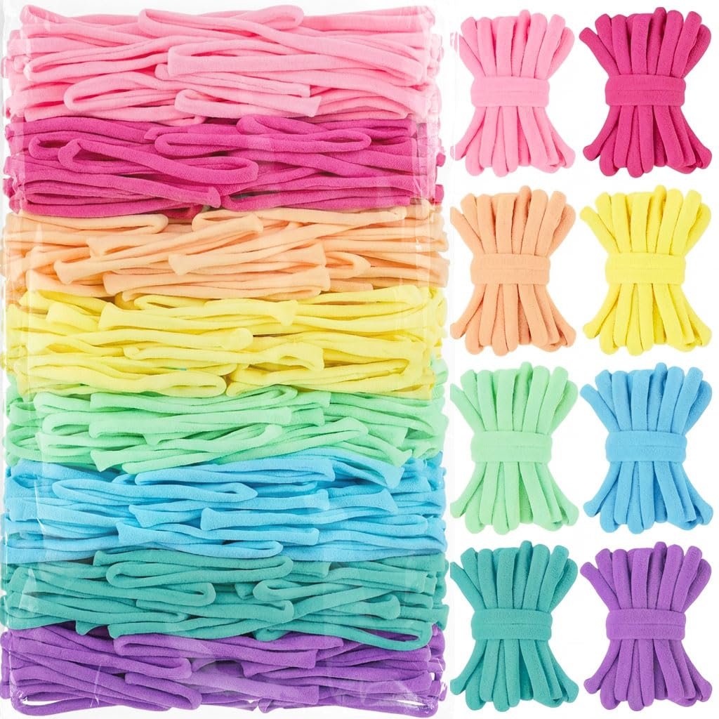 A large package of colorful nylon loom loops in pink, peach, yellow, green, blue, and purple, with smaller bundles of loops arranged to the right.